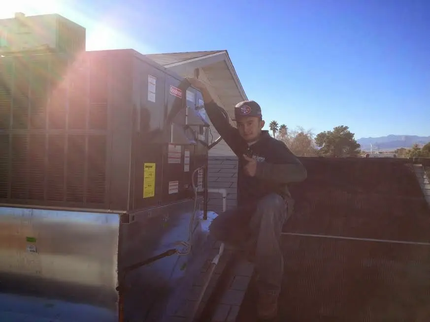 HVAC technician performing AC Tune-Up on a rooftop unit in Penn Hills